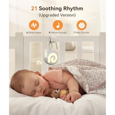 Dreamegg D11 sound machine beside a sleeping baby in a cot